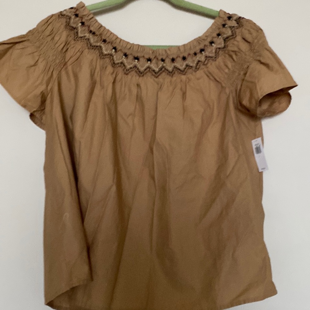 Cotton blouse with embroidery at neckline.  Elastic detail in sleeves.